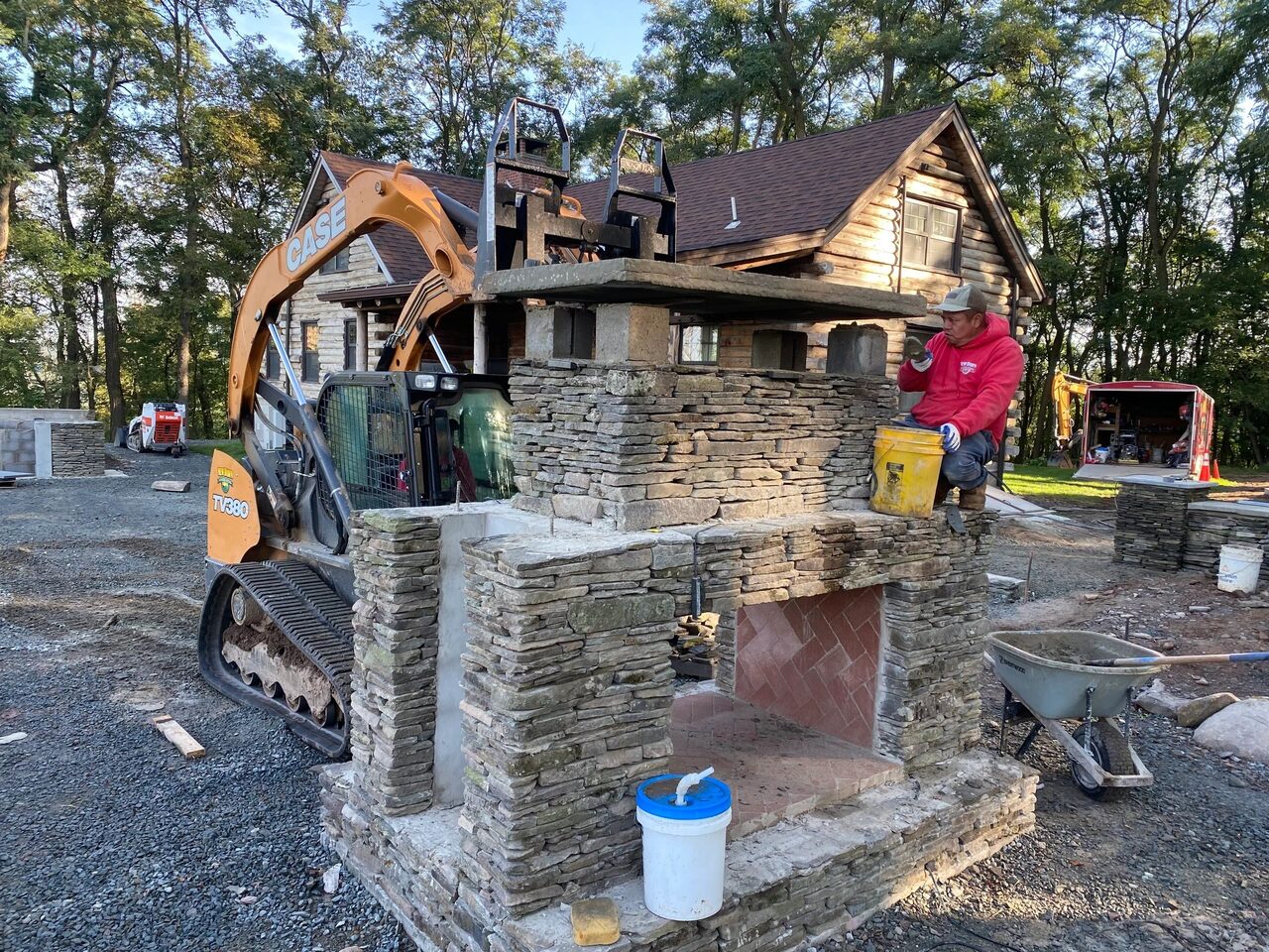 Custom outdoor stone fireplace and kitchen build in Princeton Junction, NJ. New Dawn Landscaping.